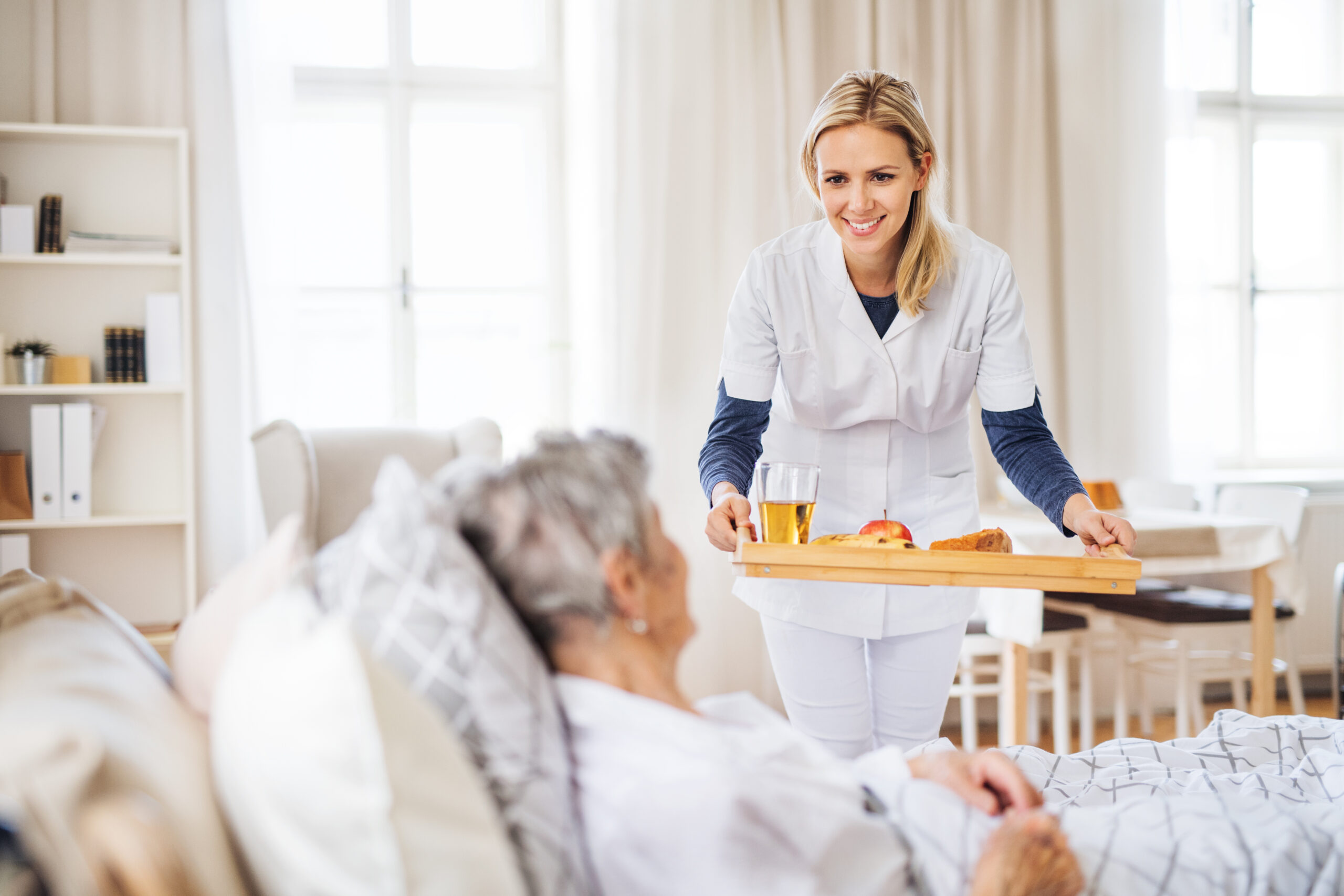Amazing Grace Home Care – Home Care Caregiver preparing a nutritious meal for an elderly client in La Crosse, Kansas.