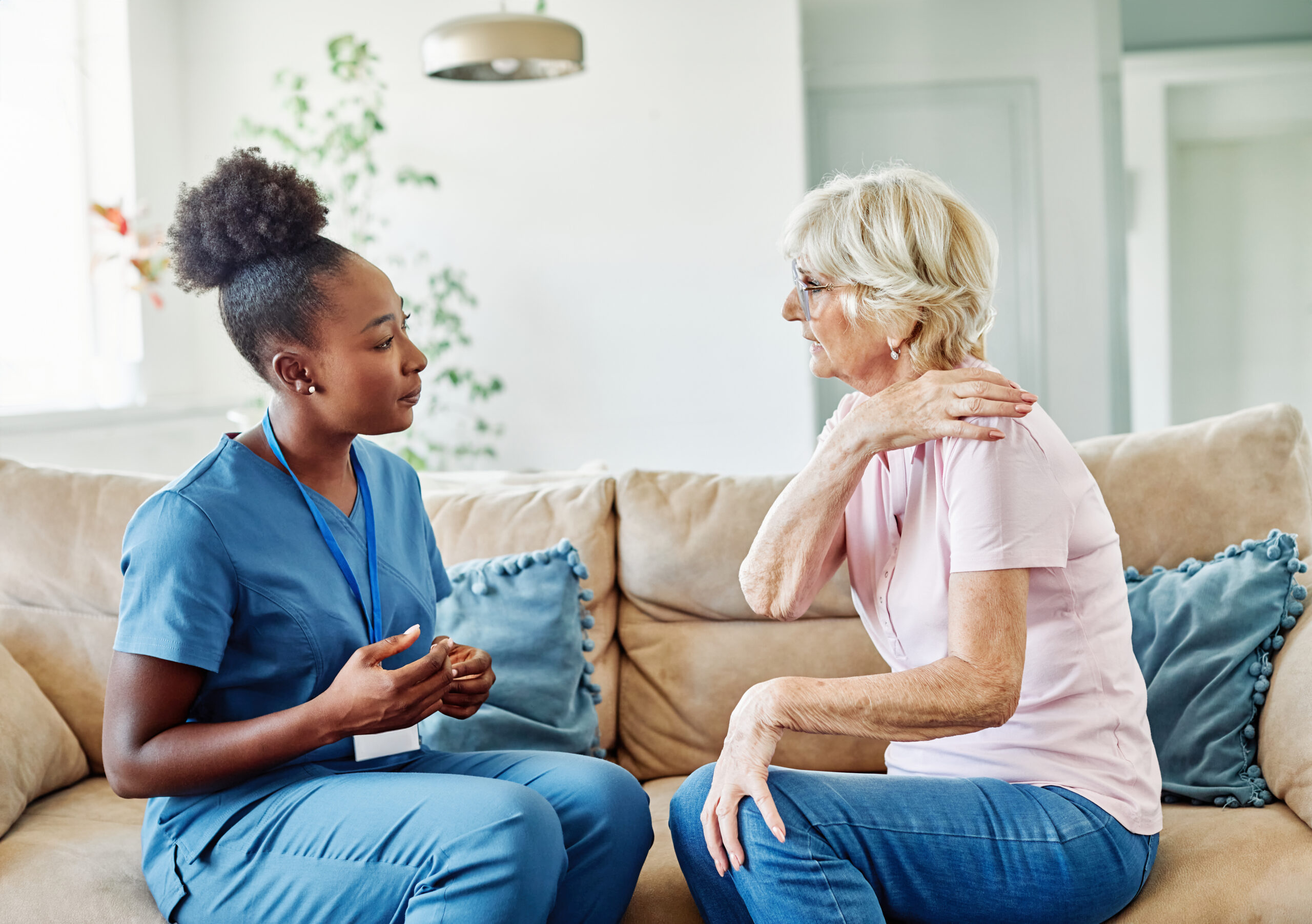 nurse senior ache backache home care patient pain retirement nursing elderly old woman caregiver doctor shoulder arm elbow Compassionate aged care Catharine KS helping seniors remain independent at home